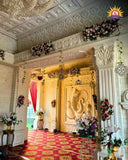 Wedding hall entrance with Ganesh relief and floral decor in FRP