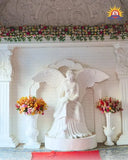 White FRP angel statue with flower vases and floral backdrop