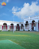 White arched FRP venue building with lawn and red drapes